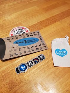 a bag and some stickers on a wooden table