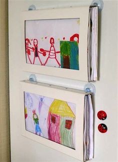 two pictures are hanging on the wall with magnets attached to them and one has been made out of crayons