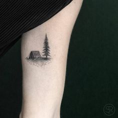 a black and white photo of a pine tree tattoo