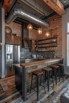 an industrial style kitchen with brick walls and stainless steel appliances, bar stools, wood flooring and exposed lighting