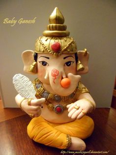 an elephant statue sitting on top of a wooden floor