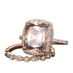 an engagement ring with a large pink diamond surrounded by diamonds on the sides and gold band