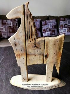 a wooden horse statue sitting on top of a bed