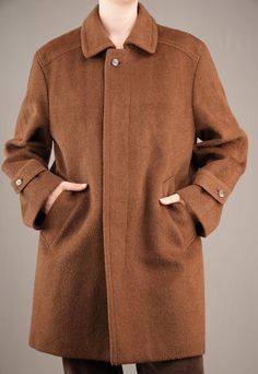 A beautiful male 90's coat by Valmeline. The warm brown wool fabric is similar to that of Loden coats, with slightly long and coarse fibers. It feels thick and sturdy, keeping you warm in those cold winter days. The inside checkered wool lining feels soft and not itchy at all. The coat is in mint condition, there are no damages whatsoever.  While it is a male coat, I would also recommend it to women that like a bit of an androgynous look. I am 175cm (5.9ft) tall and usually wear a female size M. Brown Wool Pea Coat With Button Closure, Single Breasted Brown Pea Coat For Winter, Brown Single-breasted Pea Coat For Winter, Winter Brown Pea Coat With Pockets, Brown Wool Coat With Button Closure, Brown Single-breasted Wool Coat, Brown Wool Coat For Business, Brown Wool Coat For Business In Winter, Business Brown Wool Coat