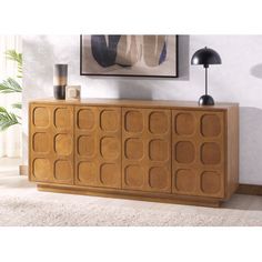 the sideboard is made out of wood and has geometric designs on it's sides