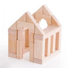 a wooden toy house made out of wood blocks