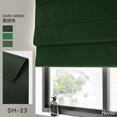 a green roman blind in front of a window with an image of a plant on it