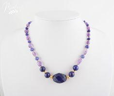 Stunningly elegant necklace made of beautifully complementing delicate purple amethysts and blue sapphires alternating with blue lapis lazuli and dark blue sapphires. Perfectly integrated in color are 4 large blue lapis lazuli gemstones and a 20mm blue sapphire in the center of the necklace. All gemstones are embedded in 18K real gold plated elements to nobly round off the combination of gemstones. Matching earrings/necklace are also available upon request so you can wear it as one ensamble. Ple Elegant Sapphire Faceted Beaded Necklaces, Blue Faceted Amethyst Jewelry, Faceted Blue Amethyst Jewelry, Elegant Sapphire Crystal Necklaces With Round Beads, Elegant Sapphire Round Beads Crystal Necklace, Elegant Lapis Lazuli Crystal Necklace With Gemstone Beads, Blue Amethyst Gemstone Necklaces, Elegant Lapis Lazuli Faceted Necklace, Elegant Sapphire Necklaces With Gemstone Beads