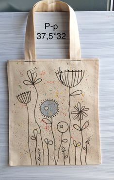 a tote bag with an image of flowers on the front and bottom, which reads p p 37 532