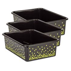 three black containers with yellow dots on them