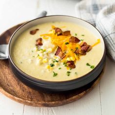 a bowl of potato soup with bacon and cheese in front of an instant pressure cooker