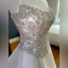 a white wedding dress on display in a store