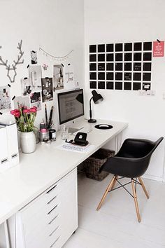 a white desk topped with a computer next to a black chair