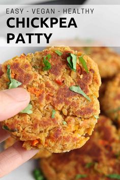 a hand holding up a chickpea patty in front of some other patties