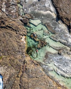 an aerial view of some rocks and water