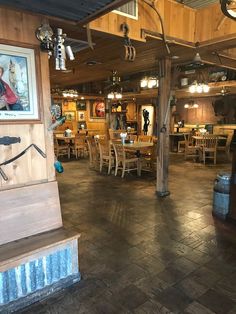 the inside of a restaurant with wooden tables and chairs