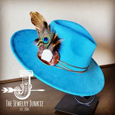 If you’re looking for the perfect accessory to complement your favorite boho style, look no further. The Boho-Style Western Felt Hat w/r Hat Band Accent by The Jewelry Junkie is absolutely everything that you need. Not only is it easy to incorporate into any and all outfits, but the genuine leather of the band immediately elevates whatever it is you’re wearing. The item that you receive in the mail will resemble the one in the picture but, because every piece by Jewelry Junkie is handmade, it wi Large Feathers, Western Hat, Leather Hat, Fedora Hats, Feather Hat, Ecommerce Website Design, Medium Handbags, Gold Feathers, Packing Jewelry