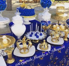 there are many blue and gold desserts on the table