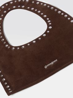 Mini shoulder bag, embellished with metal studs. Crafted with 100% leather in brown suede made in Spain. Avoid direct sunlight, intense heat, water, and excess humidity or aridity. Store in the provided flannel bag. Clean professionally by a leather or suede expert. Luxury Brown Shoulder Bag With Snap Closure, Designer Leather Bags With Rivets, Brown Leather Bags With Rivets, Designer Leather Shoulder Bag With Studs, Everyday Leather Shoulder Bag With Studs, Brown Tote Bag, Brown Tote, Saint Valentine, Mini Tote Bag