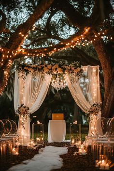 an outdoor wedding setup with candles and flowers