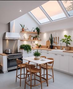 a kitchen filled with lots of counter top space next to a stove top oven under a skylight