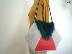 "Colourful unique hexagonal faux fur colour block shoulder bag, gift for women, 80's style bag Add instant impact to your outfit with this vibrant, tactile and colourful shoulder bag.  Retro, but modern in it's styling, this totally unique bag is a one-off (only one made in this particular fabric combination).  The main colour is a soft, dove-grey 'shearling' type short faux fur, and central triangle a bold coral pink wool mix.  The flap is made from an ultra-soft two-tone turquoise faux fur and features a magnetic snap fastener on it's inside for security.  The inside is fully lined in a mid-century style 'matchstick' Liberty print cotton in ivory, black, grey and red.  It also has a small inside pocket, handy for your keys etc.  This bag can also be worn as a cross-body bag (please see l Fabric Combinations, Liberty Print, Unique Bags, Dove Grey, Colour Block, 80s Fashion, Mid Century Style, Lining Fabric, Coral Pink