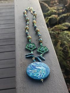 Proud as a Peacock 2 | Etsy Artistic Blue Beaded Necklace, Bohemian Peacock Necklace As Gift, Bohemian Peacock Necklace For Gift, Artistic Green Necklace For Festivals, Traditional Hand Painted Adjustable Necklace, Traditional Adjustable Hand Painted Necklace, Adjustable Hand Painted Spiritual Necklaces, Nature-inspired Green Jewelry With Wooden Beads, Multicolor Peacock Design Bohemian Necklace