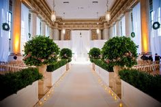 an indoor wedding ceremony with flowers and greenery