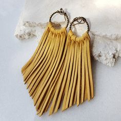 "Long Fringe Leather Earrings- Leather Fringe Earring - Boho Earrings - Fringe Earrings - Tassel Earrings - Western Jewelry- Western Earrings - Gift This listing is for a handmade Genuine Leather Fringe Earrings with nickel free ear wires. Colors: golden yellow shiny leather, this leather has a very soft flexible temper * Leather measures approx 4 inches, with hoop jump ring approx 5 inches All earrings are handmade by yours truly! I have multiple sizes, shapes, patterns and colors available! Sp Gold Tassel Earrings For Festivals, Adjustable Gold Bohemian Tassel Earrings, Yellow Fringe Dangle Jewelry, Gold Fringe Tassel Earrings For Festival, Adjustable Gold Tassel Earrings With Fringe, Yellow Fringe Tassel Earrings, Adjustable Fringe Tassel Dangle Earrings, Yellow Bohemian Jewelry With Latkans, Bohemian Yellow Jewelry With Latkans