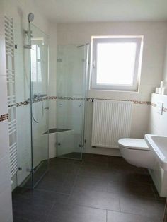 a bathroom with a sink, toilet and shower