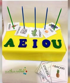 a cake that has been made to look like a yellow box with the word aeiou on it