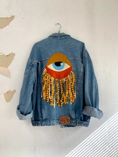 a denim jacket with an eye on it