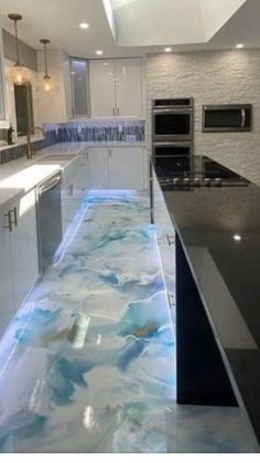 a modern kitchen with blue and white marble flooring