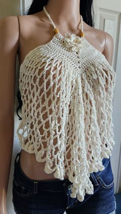 a mannequin wearing a white crochet top