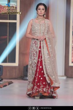 a woman in a red and white outfit on the runway