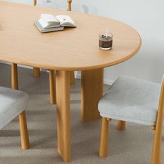 a table with two chairs and a book on it