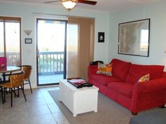 a living room filled with furniture and a sliding glass door