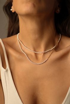 "Tiny Pearl Necklace Simple and feminine!  This timeless classic piece can perfectly be layered with other necklaces or pendants. A great gift for yourself or a loved one. Pearl necklace style: ♦️ natural freshwater pearl choker 16\"+2\" extender chain ♦️ half pearl necklace 16\"+2\" extender chain Details: * Pearl size: around 3mm  * Material: natural white freshwater pearls, 18k PVD gold-coated over stainless steel * Length:16\"+2\" chain extender  waterproof, hypoallergenic, nickel-free, grea Elegant White Necklace With Double Chain, Elegant Layered Pearl Necklace As Gift, Elegant Pearl Layered Necklace As Gift, Elegant White Double Chain Necklace, Elegant Pearl Layered Necklace Gift, Elegant White Layered Necklace With Adjustable Chain, Elegant Pearl Necklace With Chain As Gift, Elegant Everyday Pearl Necklace With Chain, White Classic Clavicle Chain Necklace