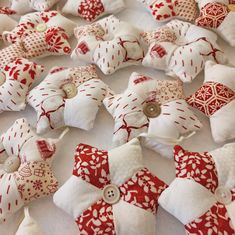 many red and white decorative items are on the table with one button in the middle