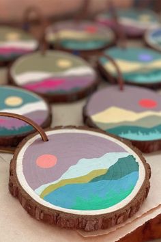 several decorated cookies sitting on top of a wooden table next to each other with circles painted on them