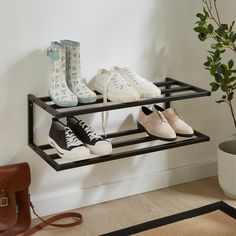 there are many pairs of shoes on the shelf