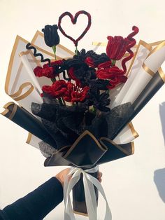 a bouquet of flowers is being held by someone's hand