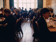 a group of people sitting at tables in a restaurant