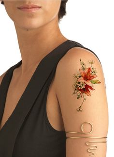 a woman with tattoos on her arm and shoulder