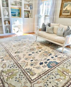 a living room filled with lots of furniture and rugs