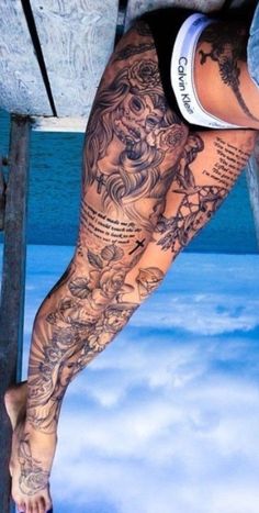 a person with tattoos on their legs and leg