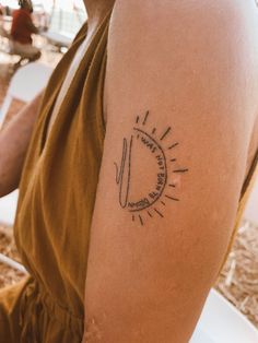 a person with a tattoo on their arm sitting in front of a table and chair