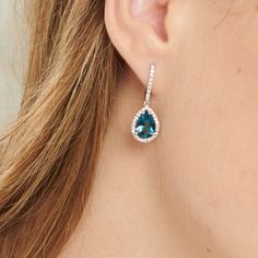 These luxurious large teardrop blue topaz stone dangle earrings with VS1 Diamonds and 14k white gold are a special gift that any bride will love to have. Delicately designed with beautiful details, these earrings feature two large tear-shaped blue topaz stones surrounded by VS1 grade diamonds of the highest quality, all set in 14k white gold. The simplicity of the design is what makes it stand out from the ordinary, representing timeless elegance and sophistication. Their delicate sparkle and shine is sure to be a perfect accent for any attire, giving any bride a true sense of royal beauty.  Charmingly classic yet on trend, these earrings are made to last a lifetime - the perfect gift that she will cherish forever for her special day. ✦ Earrings Details -       Gold weight: 6 grams - Royal Beauty, Metal Workers, Vs1 Diamond, Stone Dangle Earrings, Blue Topaz Stone, Topaz Stone, Diamond Clarity, Luxury Jewelry, Special Gift