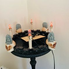 a table with candles on top of it in the shape of an elephant's head