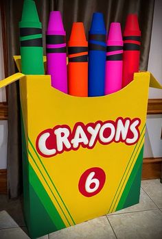 crayons are in a cardboard box on the floor